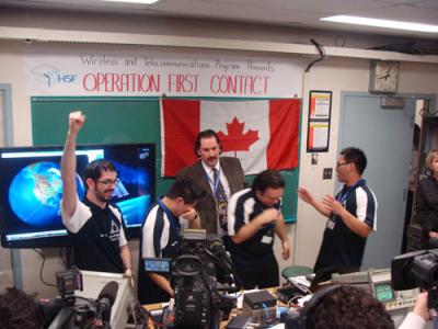 From left, Patrick Neelin, Paul Je, Gino Cunti and Kevin Luong, with their professor Mark Rector, are overcome after their successful contact with the space station. From left, Patrick Neelin, Paul Je, Gino Cunti and Kevin Luong, with their professor Mark Rector, are overcome after their successful contact with the space station.