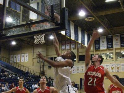 Forward Raymond Munier battles his way to the Royal’s basket for two of his game high 18 points. Forward Raymond Munier battles his way to the Royal’s basket for two of his game high 18 points.